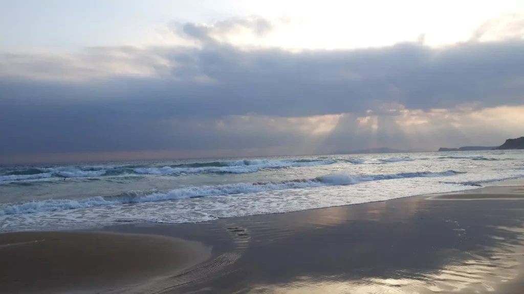 corfu arillas beach waves clouds and sun rays 7 1920w 1024x576