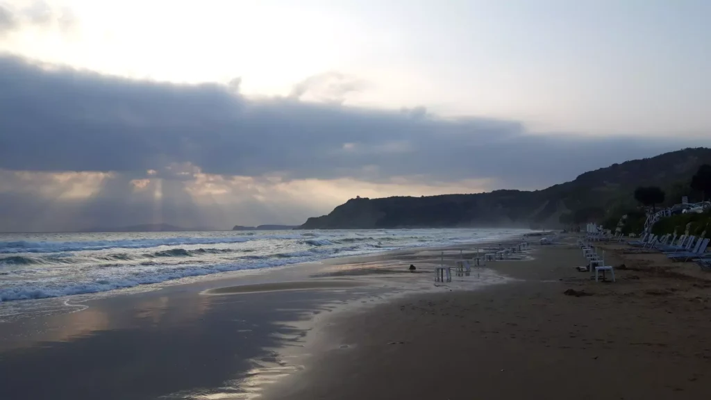 corfu arillas beach waves clouds and sun rays 8 1920w 1024x576