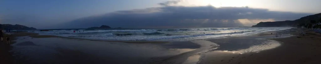 corfu arillas beach waves clouds and sun rays panoramic 1920w 1024x205