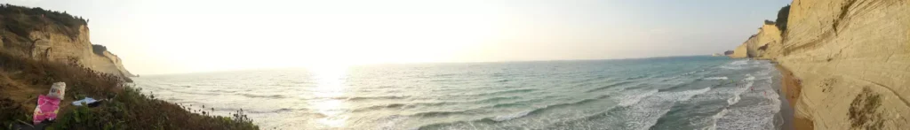 corfu loggas beach with people panoramic view 1920w 1024x147