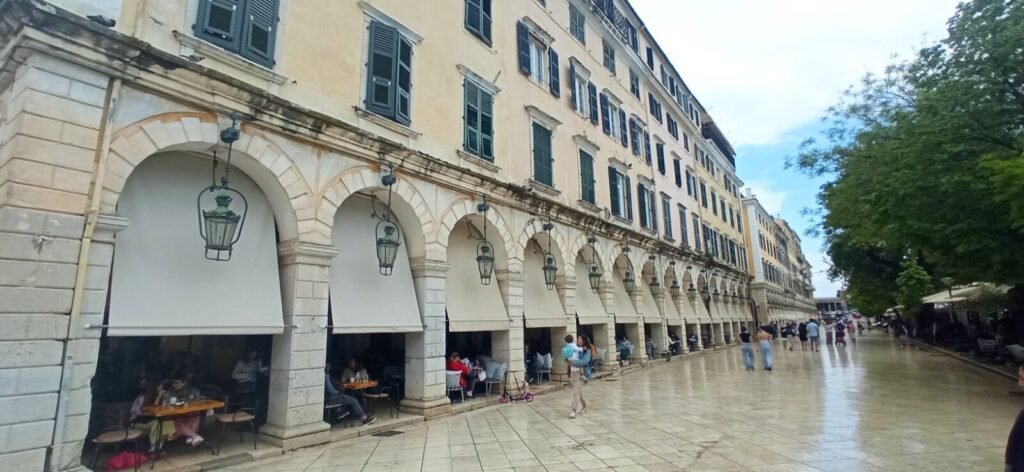 People walking towards the Liston pedestrian street during a spring rainy day